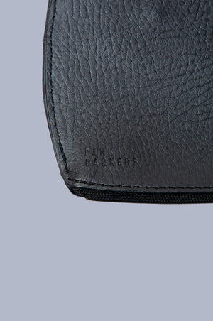 Close up view of Boboli poo bag holder of the bottom left, featuring embossed Park Barker's logo