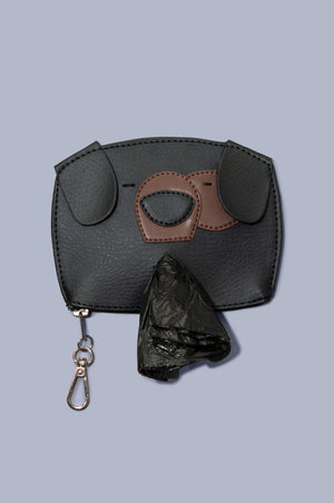 Front view of Boboli poo bag holder. Cute dog face shaped poo waste bag holder with dispenser hole at the mouth position on the front with bag emerging. Looks so cute! Gold clasp doubles as wide zip feature at bottom of the bag holder